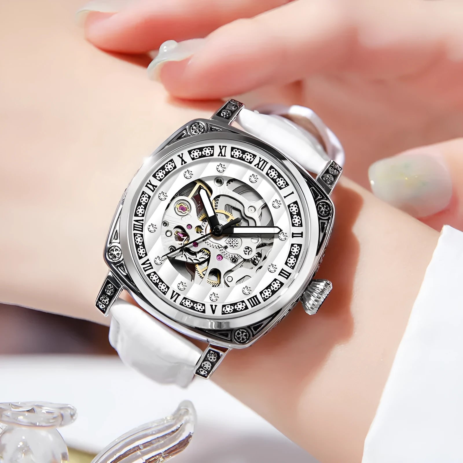 Mechanical watch with luminous hands and a black leather strap, showing 10m water resistance.