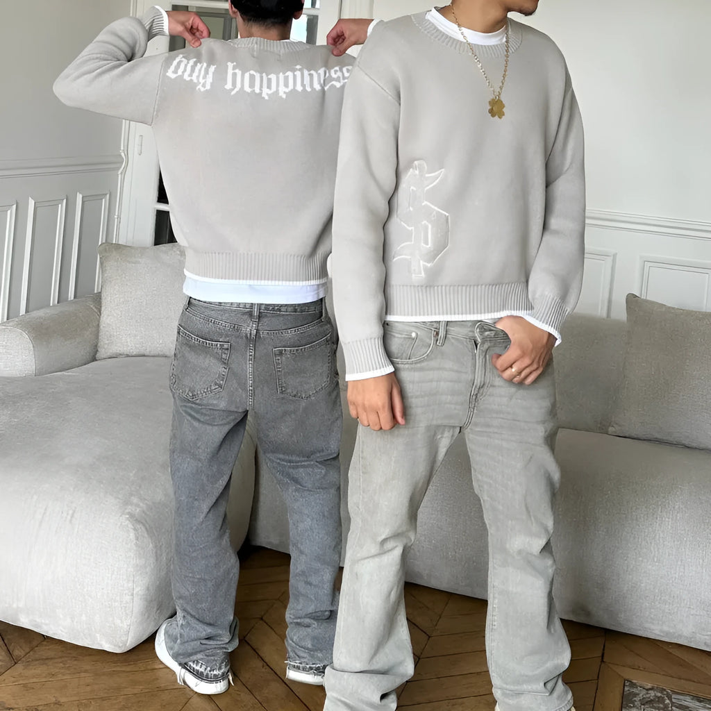 Grey loose-fitting long sleeve knitwear coat on a hanger.