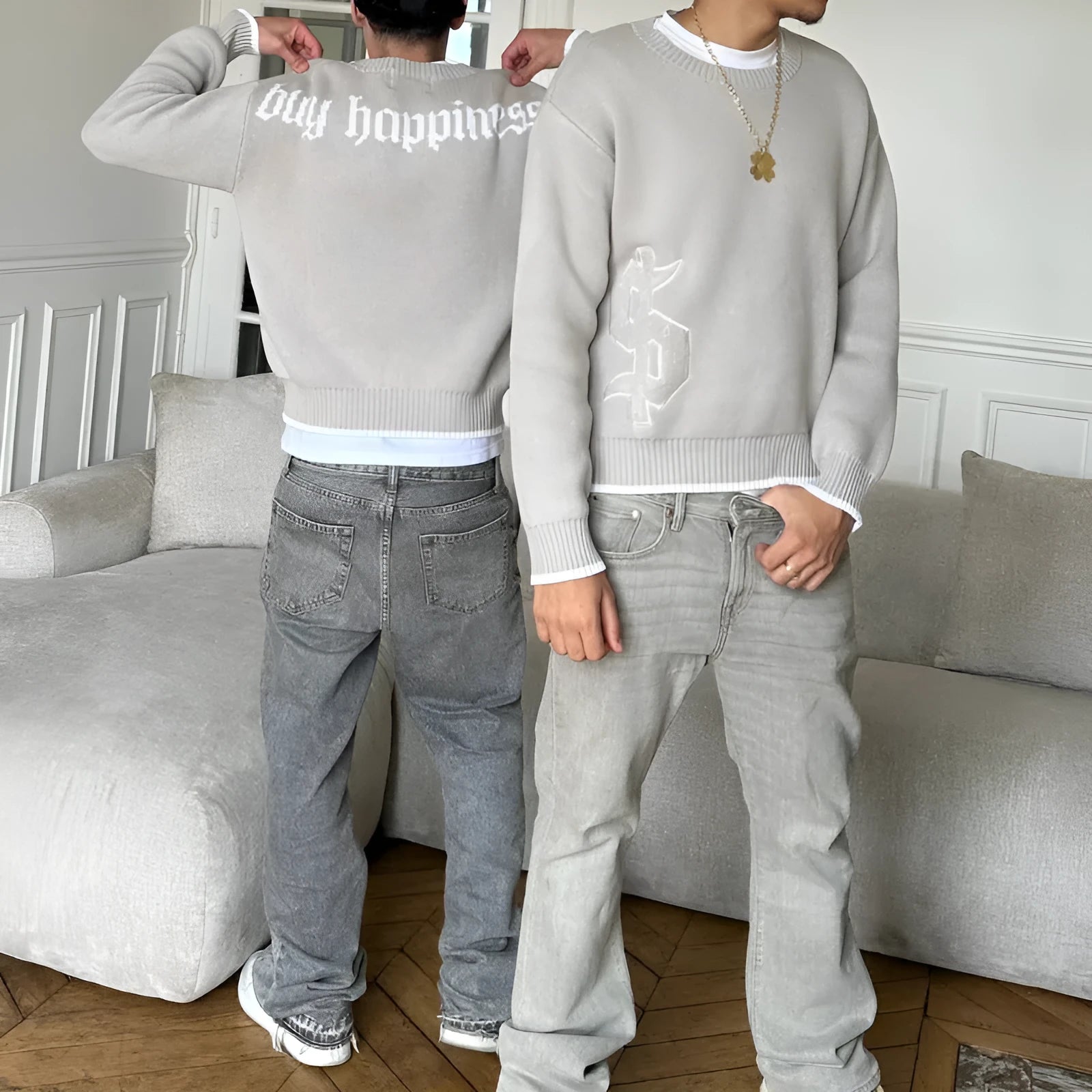 Grey loose-fitting long sleeve knitwear coat on a hanger.