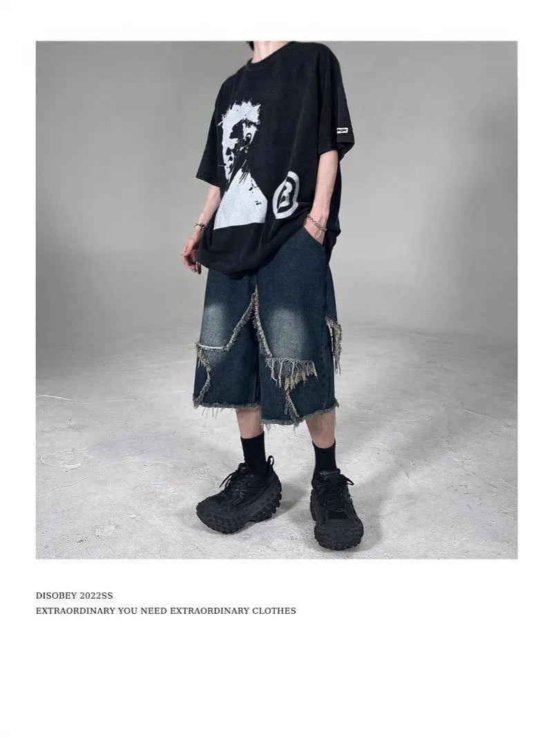 Blue denim shorts with distressed five-pointed star detailing and frayed hem, loose fit retro style