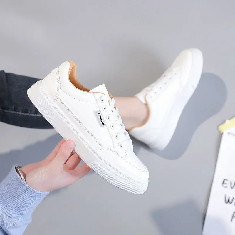 Korean style low-top sneakers in white and brown artificial PU leather with a plastic sole.