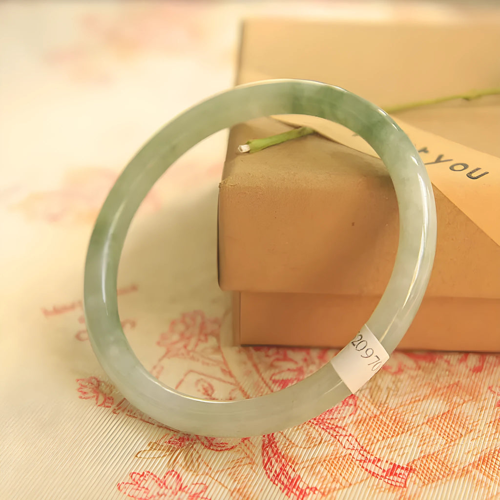 Green jade waxy student bracelet with geometric Chinese design showing adjustable sizing options