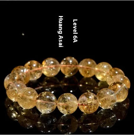 Natural yellow citrine gemstone bracelet with geometric beads on a white background.
