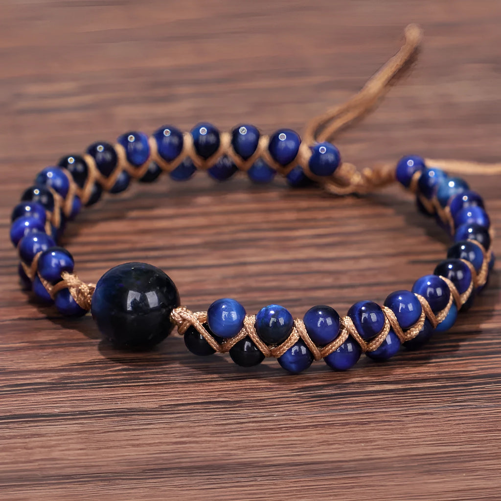 Close-up of a handmade woven bracelet with geometric tiger eye beads on an adjustable band.