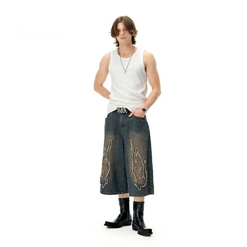 Men's black denim shorts with cropped patch flame embroidery design and straight-leg fit