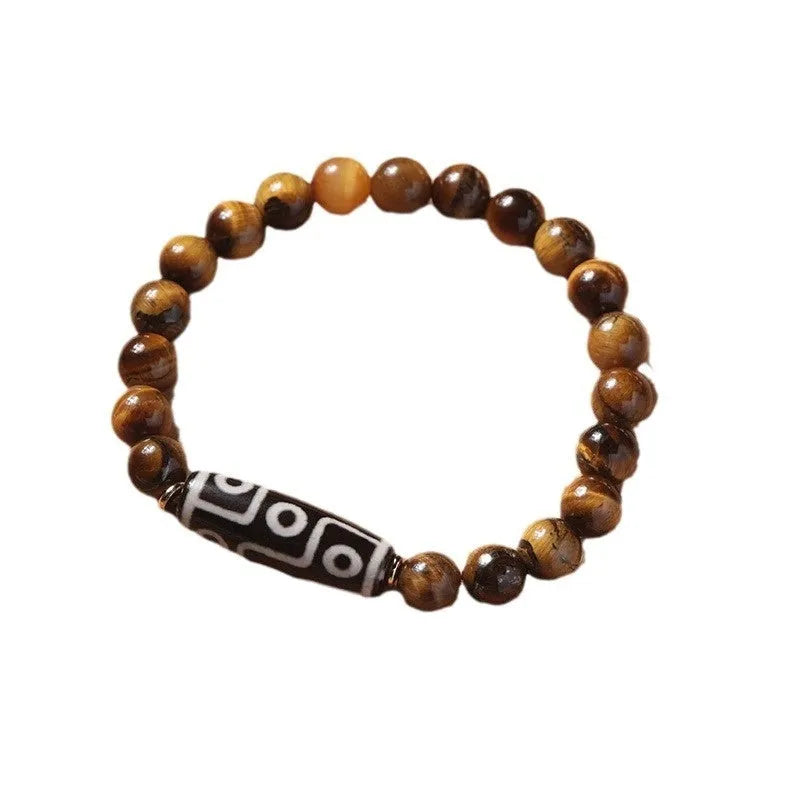 Single tigereye bead ethnic Buddha bracelet on wrist, showing simple rosary style.