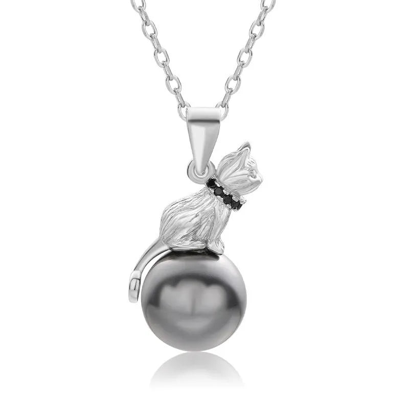 Close-up of a sterling silver cat pendant necklace on a clavicle, showing the electroplated finish.
