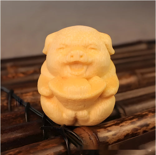 Solid bamboo carving ornament of a cute ingot pig, 4cm tall by 3.5cm diameter.