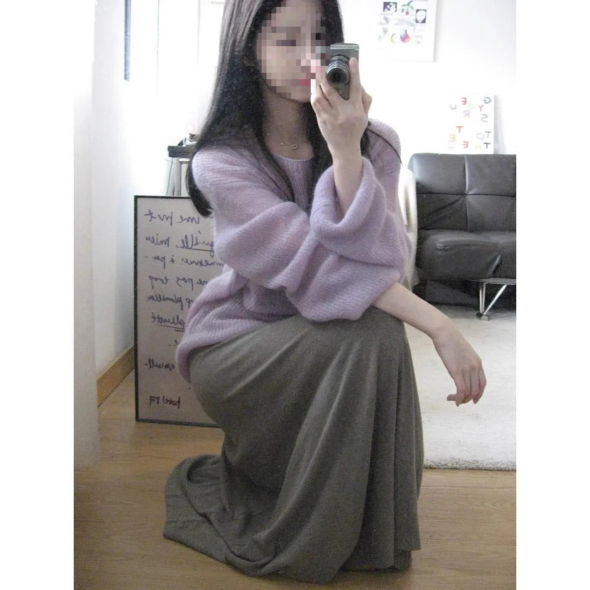 Purple women's blouse with hollow out design and sleeveless princess sleeves on a hanger.