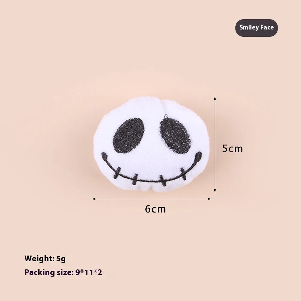Plush cat teaser toy with candy, eyes and skull attachments on handheld wand