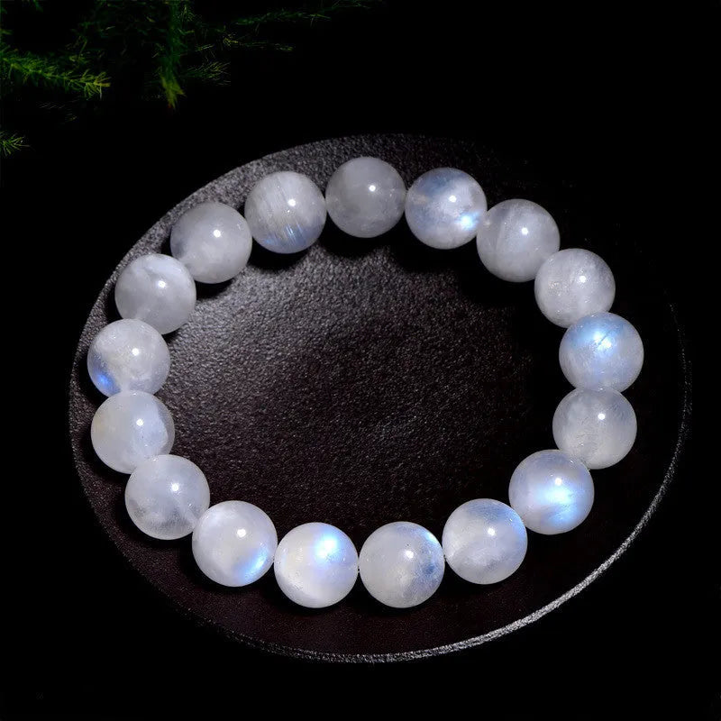 Natural blue moonlight polished round moonstone bead bracelet on a white background.