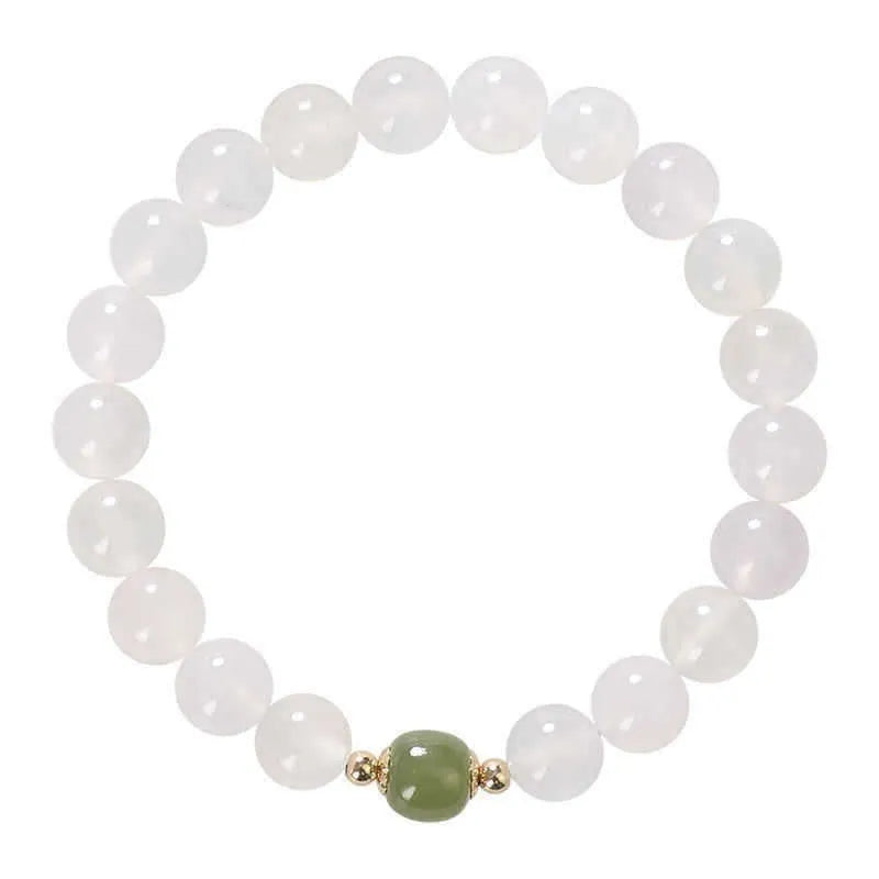 Handmade white agate and crystal bracelet with cinnabar inlay and text charm.