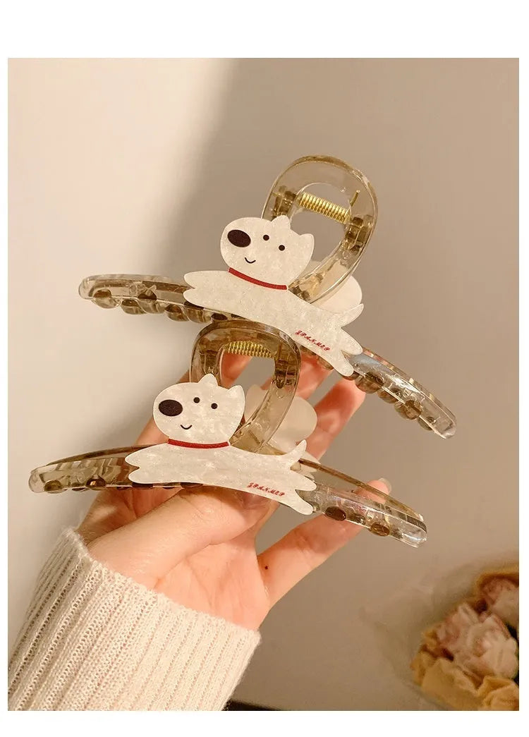 Cartoon puppy design hair barrette clip in beige and brown colours on a white background.