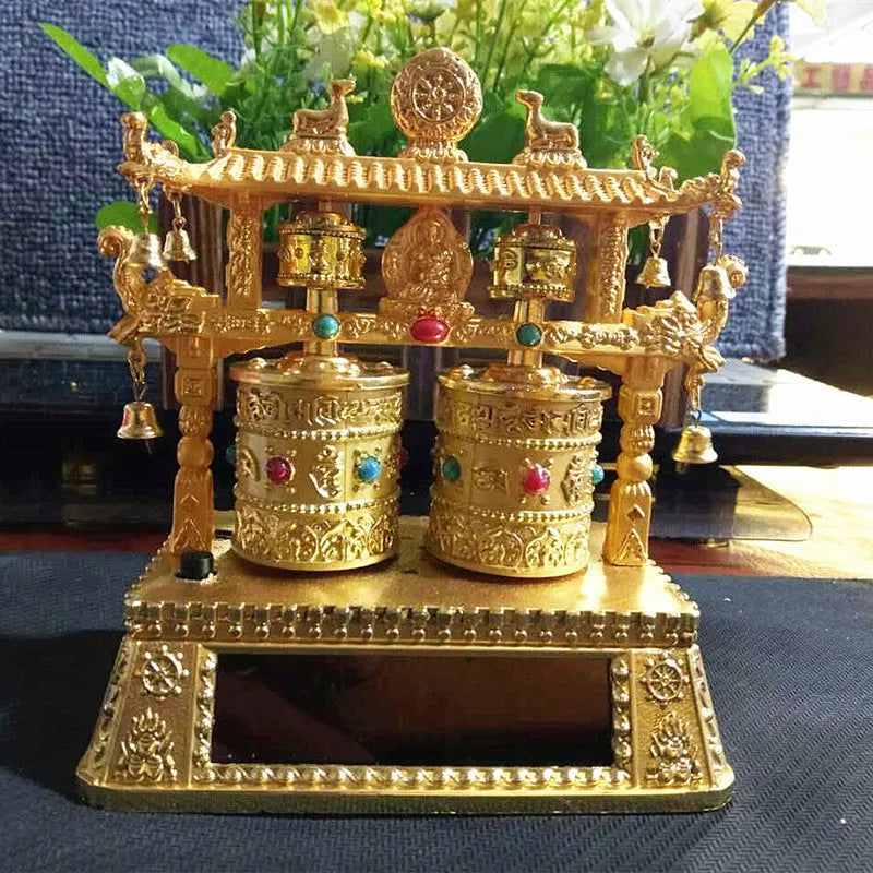 Alloy rotating prayer wheel car decoration in traditional Chinese style on a car dashboard.