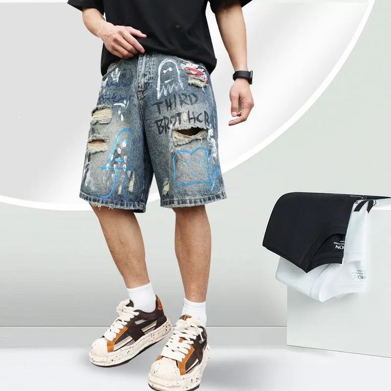 Blue denim shorts for men with rips and a graffiti pattern, featuring a zipper fly.
