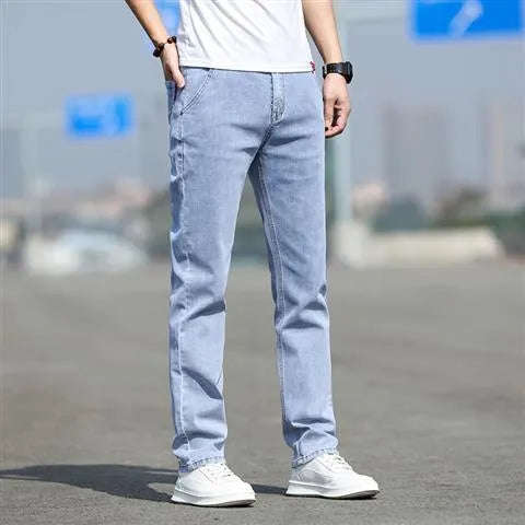 Man wearing smoky grey straight leg jeans with low waist and zipper fly.