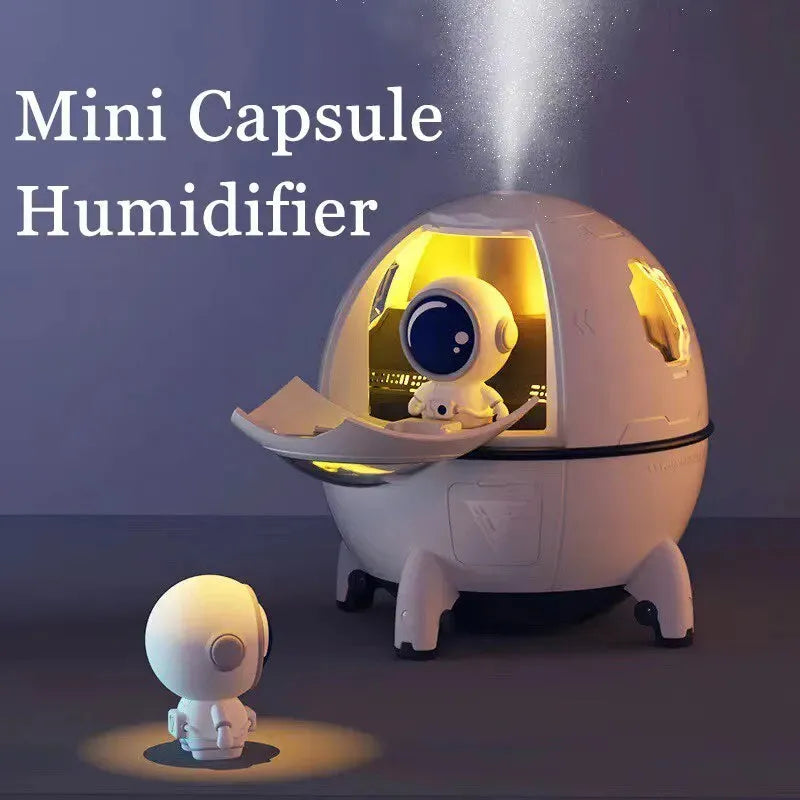 Light purple astronaut-shaped desktop USB humidifier with LED lights on a desk
