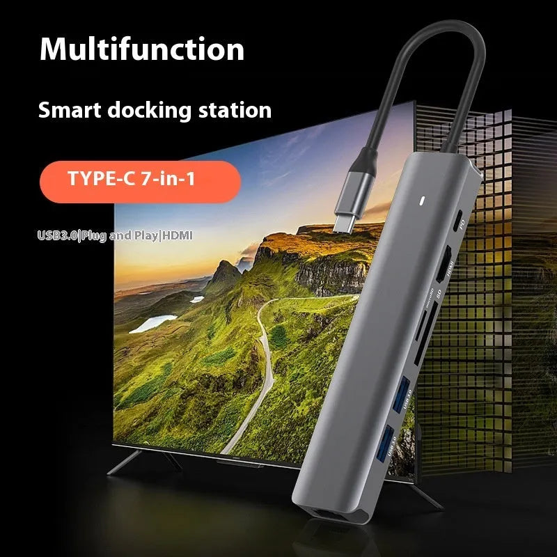 LQT-LH07 model 7-in-1 silver USB C hub showing USB-C plug, PD port, USB-A ports, and SD and microSD card slots.