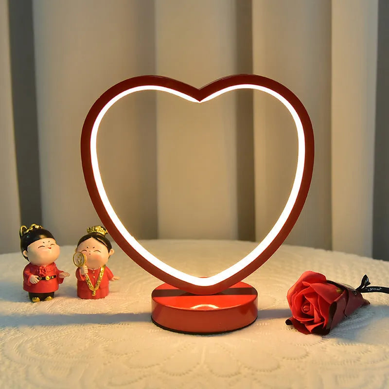 Creative red wedding lantern USB table lamp with warm light and red heart ring design on a tabletop