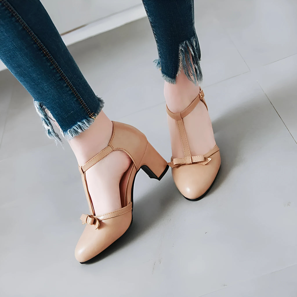 Women's chunky heel sandals with bow detail and buckle strap in solid colour.