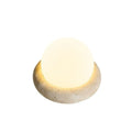 Cream style bedside night light with remote control on bedroom surface