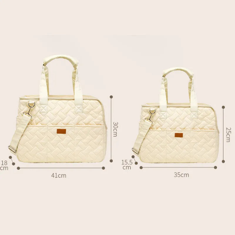 Grey pet carrier handbag with mesh panels showing interior cushion and safety cord attachment