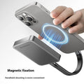 Grey magnetic mobile solid state drive with attached magnetic ring and USB C cable on a white surface.
