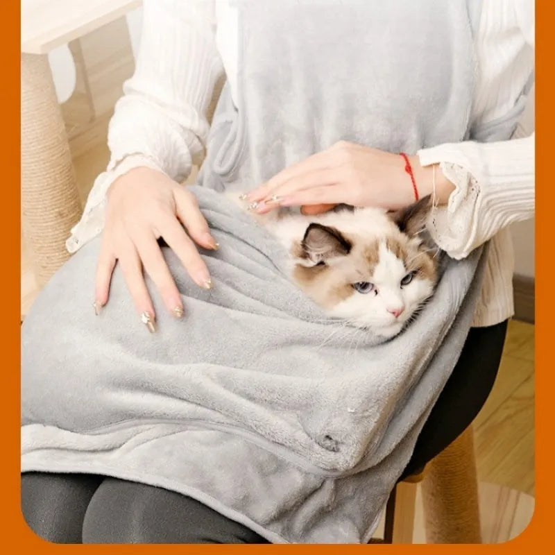 Plush pet carrier apron for small cats and dogs with adjustable strap and head opening.