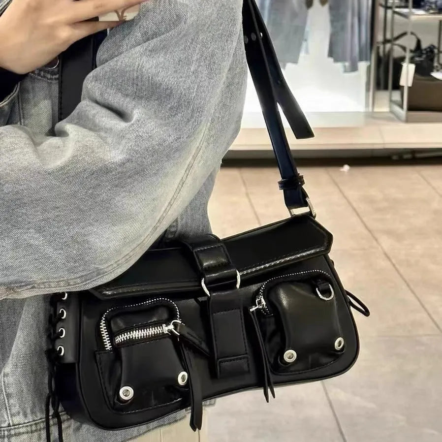 Black women's baguette style messenger bag with adjustable shoulder strap shown from front.