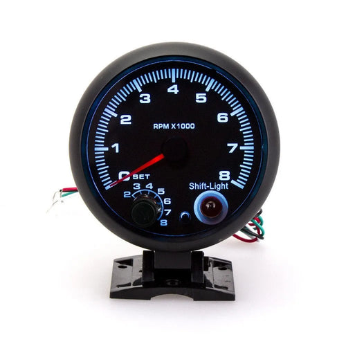 Black automotive tachometer with blue light pointer display showing engine rpm