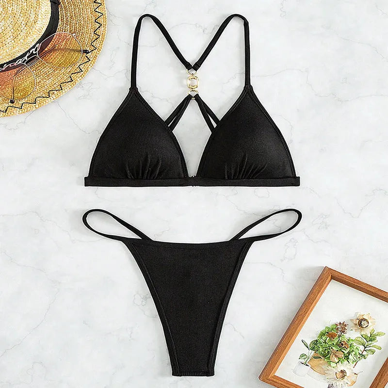 Black women's bikini set showing hollow backless triangle top and T pants.