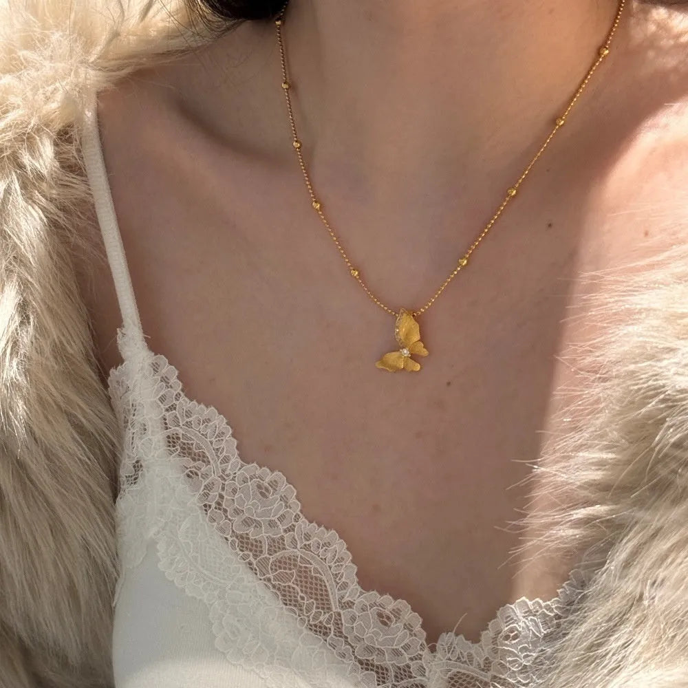 Gold-tone 925 silver butterfly necklace with frosted antique-style pendant on a clavicle chain