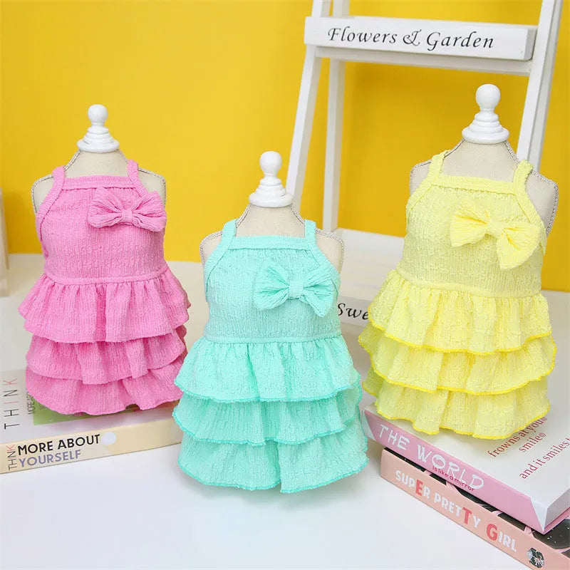 Small dog wearing princess dress with layered skirt in rose red, yellow or green