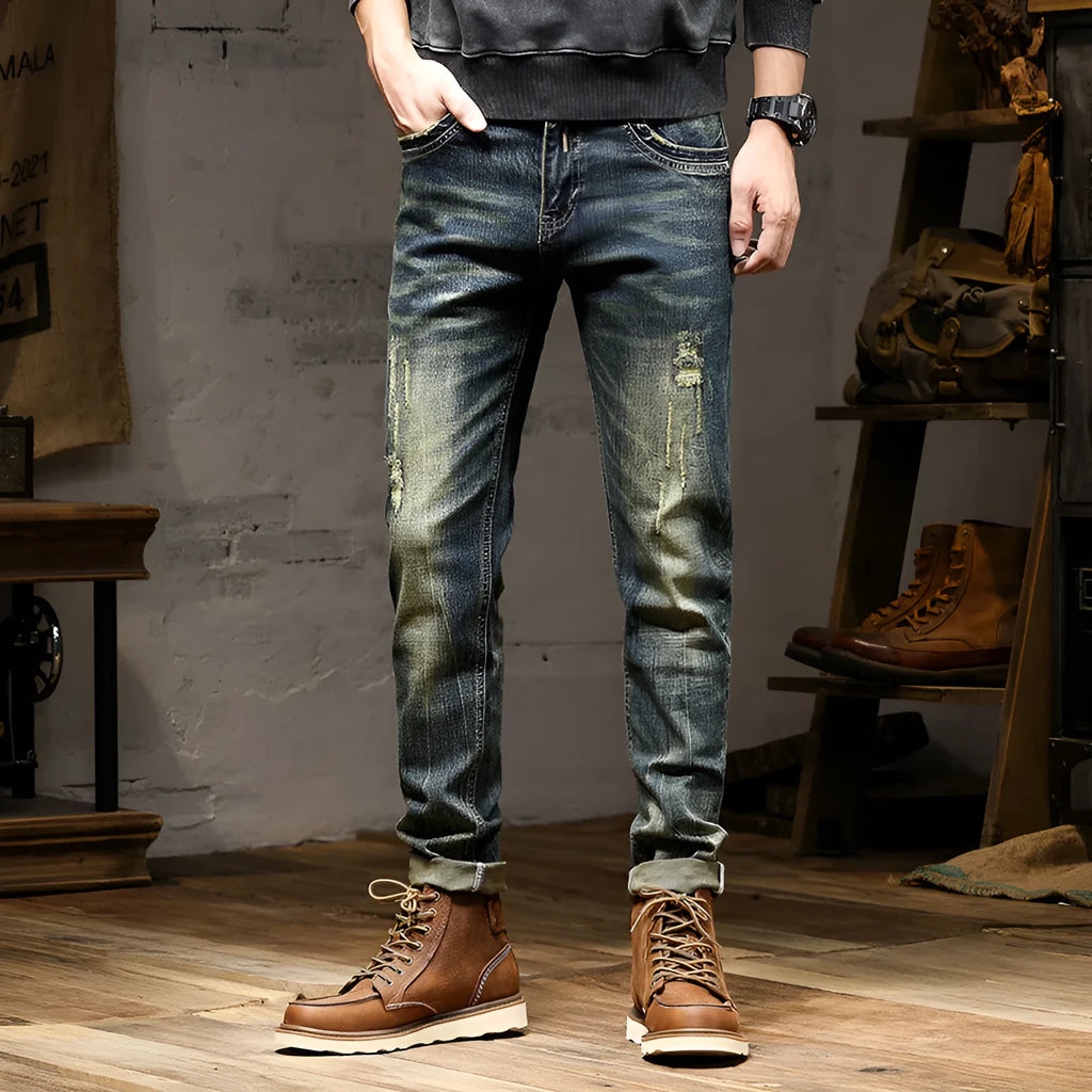 Men's slim-fit jeans in a retro colour with a zip fly, shown laid flat.