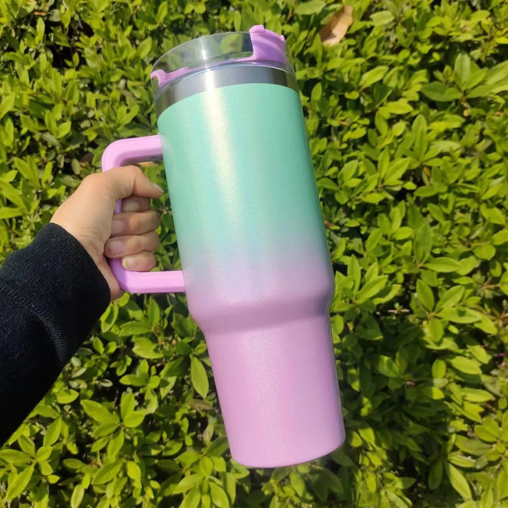 Large stainless steel vacuum insulation cup showing gradient colour options on a white background.