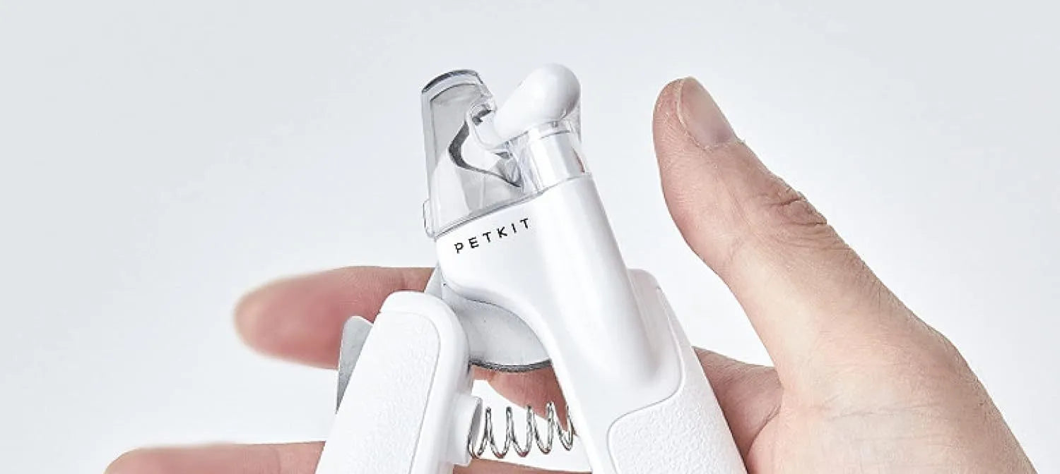 White pet nail clippers with LED light, transparent guard, triangular blades, and anti-slip handles for cat and dog grooming