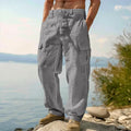 Men's loose-fitting cotton wide-leg trousers in light army green colour laid flat.