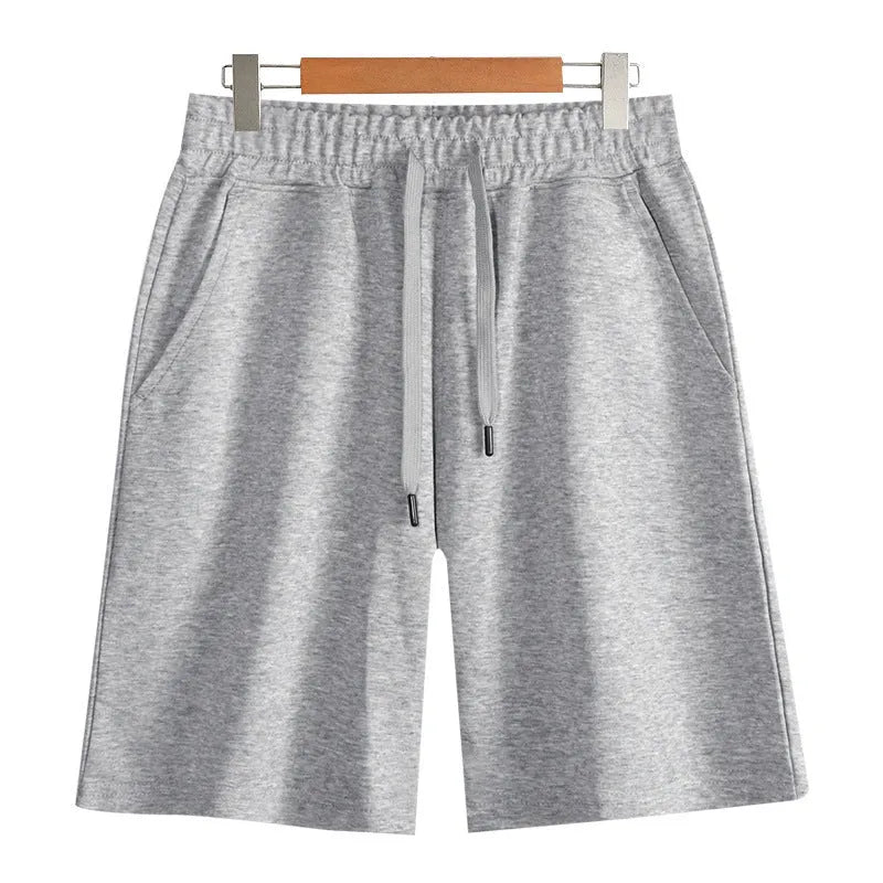 Men's and women's straight cut cotton sports shorts in multiple colours on a plain background.