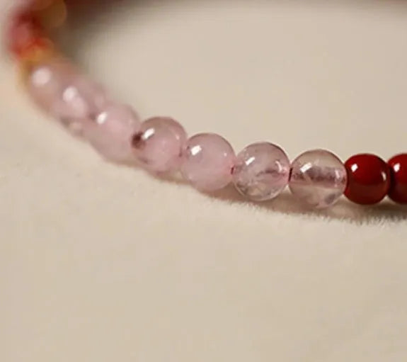 Hand-woven unisex retro Koi bracelet with Purple Gold Sand, Strawberry Quartz, and crystal beads on display