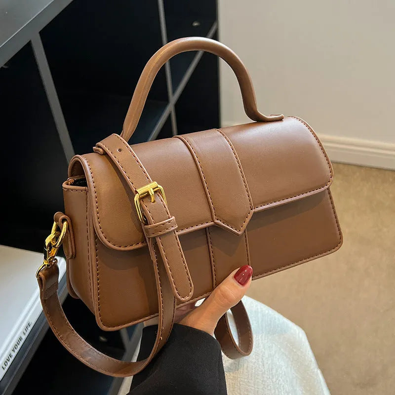 Women's beige PU messenger bag with sandwich pocket and file organiser interior.