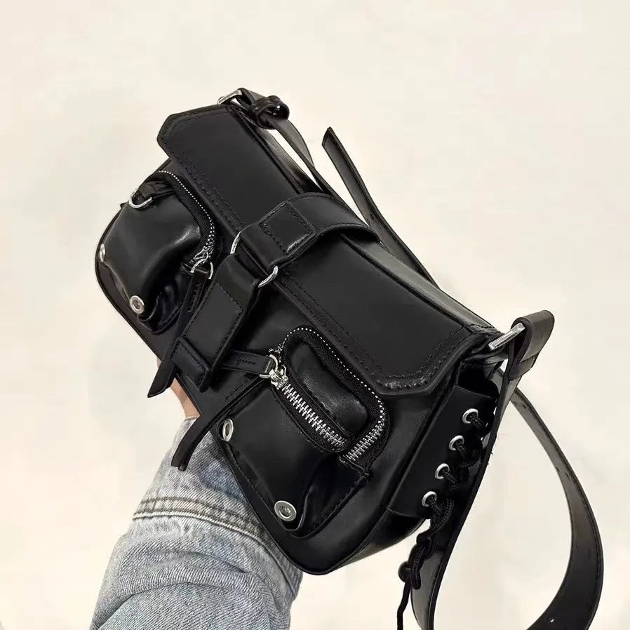 Black women's baguette style messenger bag with adjustable shoulder strap shown from front.