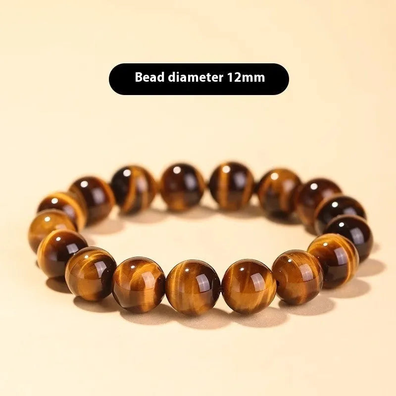 Single tigereye bead ethnic Buddha bracelet on wrist, showing simple rosary style.