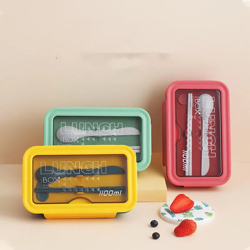 Green partitioned bento lunch box with four food compartments, shown open.