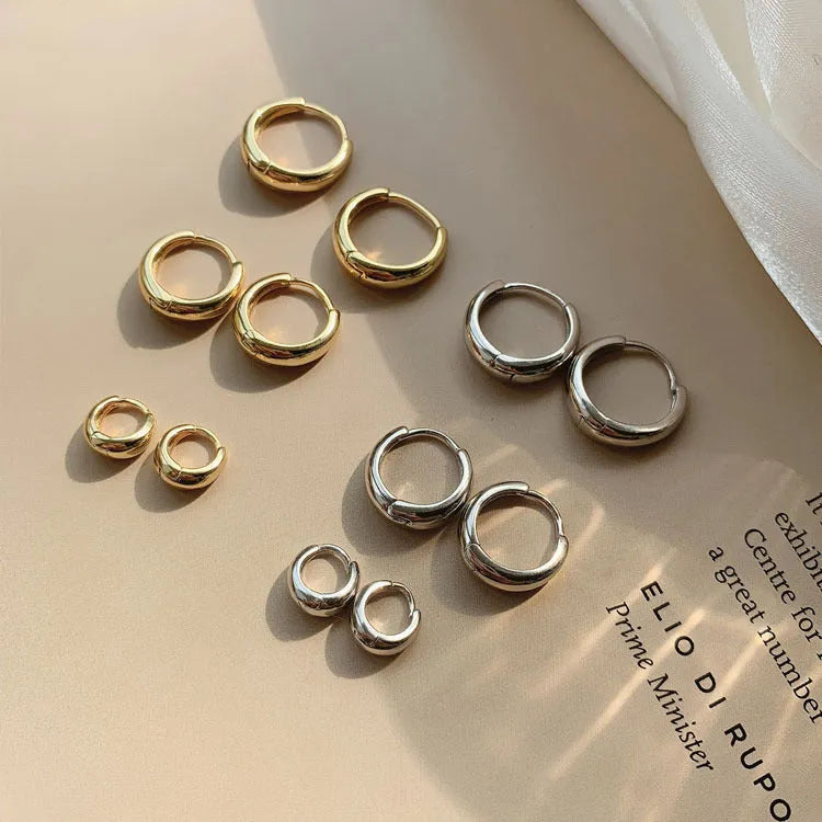 Women's minimalist geometric water drop earrings in gold or silver on a copper base, shown in large, medium, and small sizes.