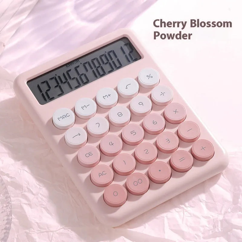 Vibrant gradient colour desktop calculator on a desk, shown in violet, pink, blue and green colour options.