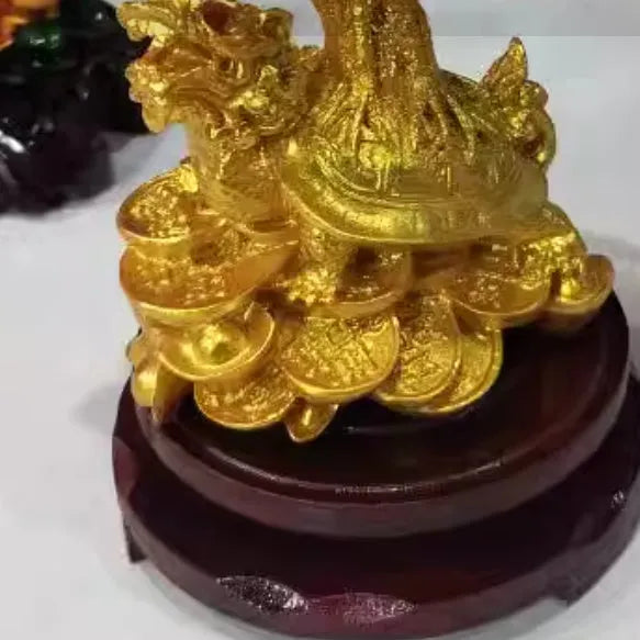 Citrine-coloured resin Feng Shui ornament of a water turtle with a money tree.
