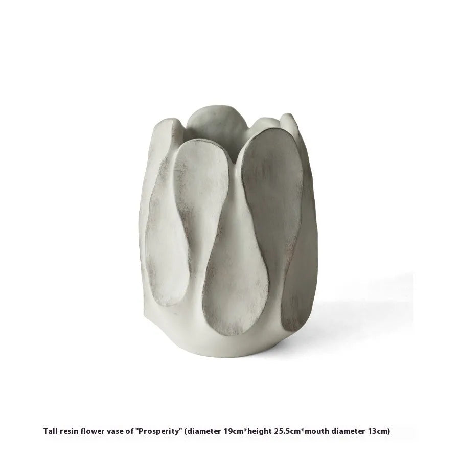 Irregularly shaped art ceramic vase in a low style profile on a wooden surface