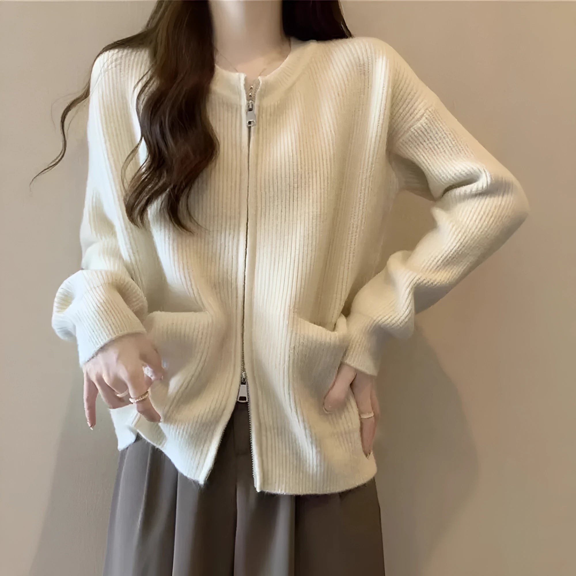 Beige soft viscose long sleeve sweater coat cardigan on a hanger.