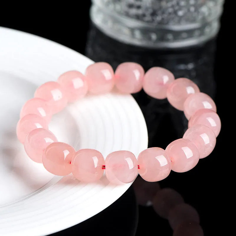 Pink natural crystal bracelet with barrel-shaped 8x10mm beads in a geometric design.