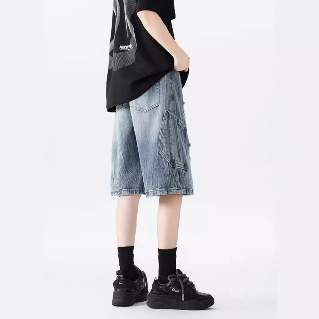 Men's loose fit distressed denim shorts in black vintage style with ripped detailing